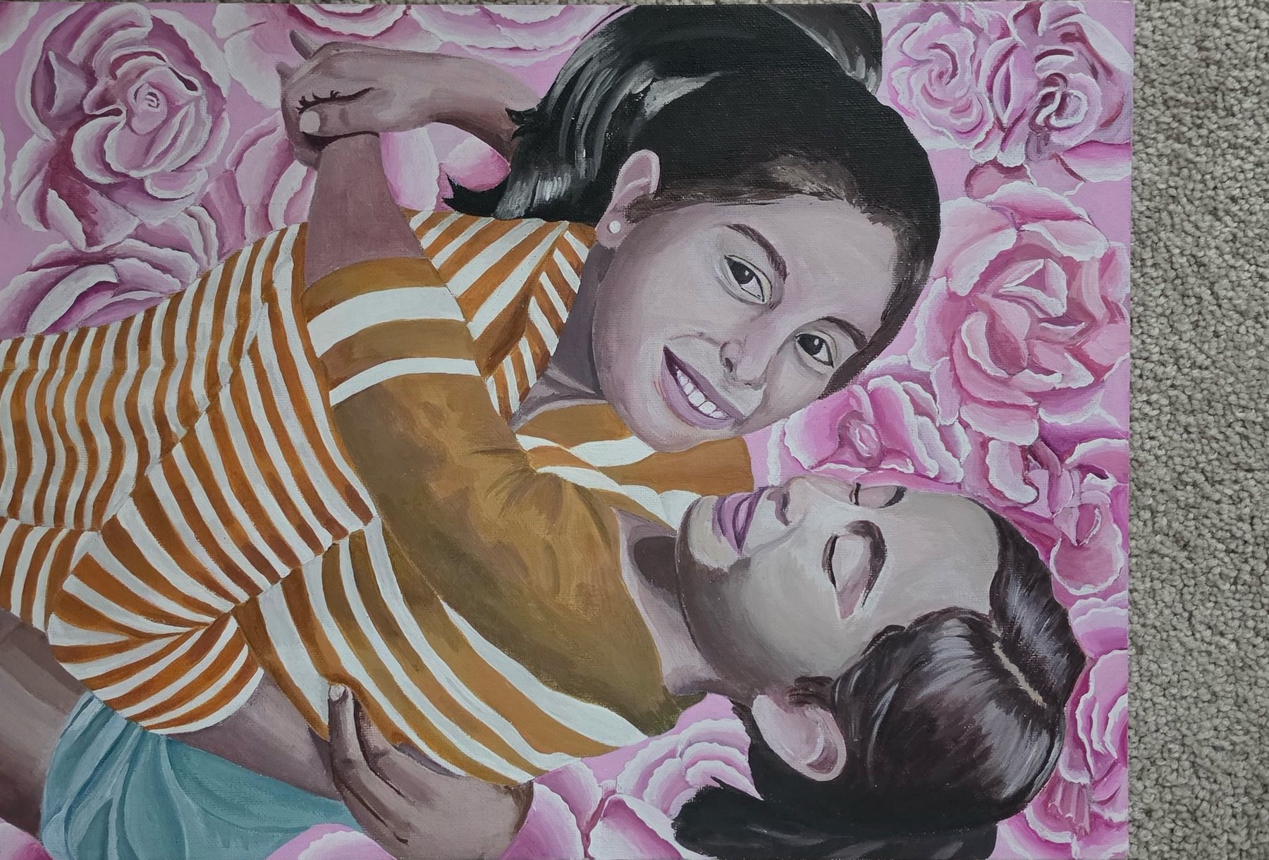 Painting of a smiling child embracing a reclining woman, surrounded by a field of pink roses.