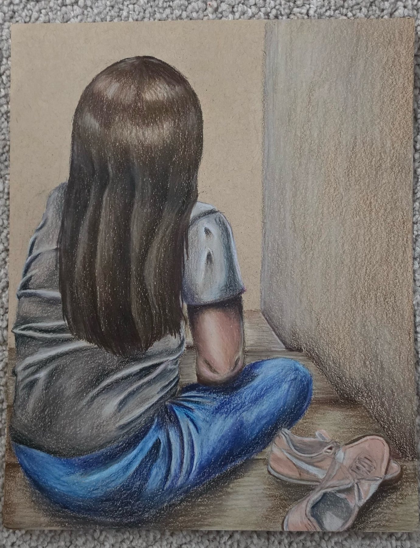 Colored pencil drawing of a girl seated on the floor, seen from behind with long hair, next to a pair of ballet flats.